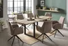 A dining room scene with a wooden table and chairs, set up for a meal. Produktbild-Vorschau