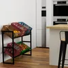A kitchen scene with a metal and wood shelving unit holding various crates filled with produce and bottles, next to a refrigerator and a counter with a stool. Náhľad obrázku produktu