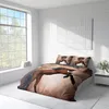 A bedroom with a bed dressed in horse-themed bedding, a large window, and a nightstand. Produktbild-Vorschau