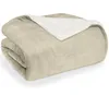 A folded beige sherpa blanket with a white sherpa lining is shown against a white background. Náhľad obrázku produktu
