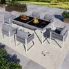 An outdoor patio set with a table and chairs on a rug. Produktbild-Vorschau