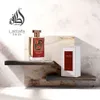 A Lattafa Pride Royal Sapphire perfume bottle and its box are displayed on wooden shelves against a marble-like background. Voir les images du produit