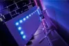 The back of a curved gaming monitor with RGB lighting, set up on a desk with shelves in the background. Náhľad obrázku produktu