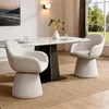 A dining room scene with a marble-topped table and two upholstered chairs. Podgląd zdjęcia produktu