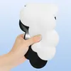 A hand is holding a white and black object against a light blue background. Podgląd zdjęcia produktu