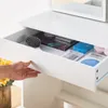 A hand is opening a drawer of a white vanity table, revealing makeup and beauty products inside. Voir les images du produit