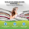 A young woman is hiding under a duvet with a striped pattern, surrounded by bedding. The image has marketing text and icons at the bottom. Produktbild-Vorschau