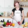 A woman in a kitchen is using a hand blender to blend berries in a glass jar. Produktbild-Vorschau