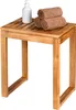 A wooden stool with towels and a soap dispenser on top, set against a white background. Produktbild-Vorschau
