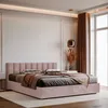 A pink upholstered bed with pillows and a throw blanket in a modern bedroom. Anteprima dell’immagine prodotto