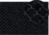 A close-up view of a black carpet with a Moroccan-inspired pattern.