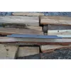 A metal grate is placed on a pile of firewood. Voir les images du produit