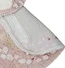 Close-up view of the underside and edge of a round rug. Voir les images du produit