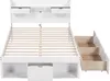 A white bed frame with storage drawers and a slatted mattress base, shown from a slightly elevated front-left angle against a white background. Podgląd zdjęcia produktu