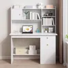 A white computer desk with shelves and drawers, set up in a room with a window and curtains. Produktbild-Vorschau