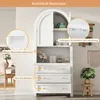 A white cabinet with arched doors and drawers, featuring decorative elements and interior details highlighted with callouts. Some decorative items like flowers and bottles are placed on the shelves. Náhľad obrázku produktu