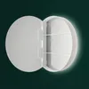 A circular medicine cabinet with its door open, revealing shelves. Anteprima dell’immagine prodotto