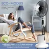 A woman is relaxing in a rocking chair in a room, with a misting fan operating in the background. Produktbild-Vorschau