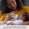 A mother is feeding her baby with a baby bottle. Produktbild-Vorschau
