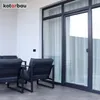 An outdoor patio area with modern furniture and large glass doors. Náhľad obrázku produktu