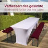 A white table cover is on a table with two benches on either side, each with a bordeaux cushion, set up on a wooden deck outdoors. Produktbild-Vorschau