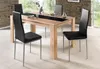 A dining table with chairs in a room. Produktbild-Vorschau