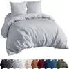 A bedding set with two pillows and a duvet cover, shown in silver. Below the main image are multiple smaller images of the same bedding set in various colors. Produktbild-Vorschau