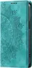 A close-up view of a teal flip phone case with an embossed mandala pattern. Produktbild-Vorschau