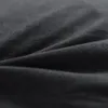 A close-up view of black fabric, showing its texture and folds. Produktbild-Vorschau