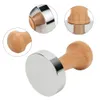 A coffee tamper with a wooden handle and a silver base, shown from multiple angles. Náhled obrázku produktu