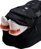 A close-up view of a black backpack with a pair of white and orange athletic shoes peeking out of a zippered compartment. Produktbild-Vorschau