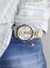 A close-up shot of a man's wrist wearing a silver Casio watch, tucked into the pocket of his blue jeans. Produktbild-Vorschau