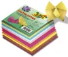 A stack of colorful origami paper sheets with a few origami creations on top and to the side. Produktbild-Vorschau