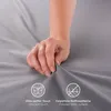 A hand is shown pressing into a soft, gray fabric, highlighting its texture and comfort. Icons and text indicating 'Ultra soft touch' and 'Polished fabric surface' are present. Anteprima dell’immagine prodotto