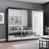 A living room scene with a large mirrored wardrobe reflecting a sofa and coffee table. Produktbild-Vorschau