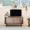 A TV stand with a television and decorative items in a room setting. Anteprima dell’immagine prodotto