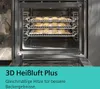 An open oven with multiple racks of cookies being baked. Produktbild-Vorschau