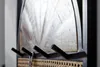 Close-up of a wall-mounted coat rack with wooden panel and woven basket detail. Produktbild-Vorschau