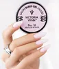 A hand with manicured nails holds a jar of nail gel in front of a white background. Náhled obrázku produktu