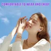A woman wearing earbuds and jewelry, with a blue sky in the background. Produktbild-Vorschau