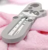 A raccoon-shaped thermometer resting on a pink towel. Náhled obrázku produktu