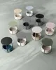 A collection of small, round side tables with built-in storage baskets, arranged on a light gray surface. Náhled obrázku produktu