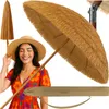 A woman wearing a straw hat and a floral dress is smiling next to a closed and open Hawaiian-style beach umbrella. Voir les images du produit