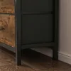 Close-up view of the bottom section of a dresser with wooden drawers and a black metal frame. Náhled obrázku produktu