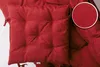 A close-up view of a red tufted seat cushion, with a magnified inset showing the fabric texture. Produktbild-Vorschau