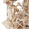 A close-up view of a wooden mechanical model, likely a marble run or puzzle. Voir les images du produit