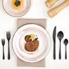 A flat lay of a place setting with a main course and a dessert plate, along with cutlery and salt and pepper grinders. Produktbild-Vorschau