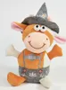 A plush toy cow wearing a traditional hat and lederhosen, sitting against a white background. Produktbild-Vorschau