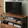 A TV stand with a TV and electronic devices. Podgląd zdjęcia produktu