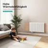 A child plays on the floor in a living room with a radiator on the wall. Produktbild-Vorschau
